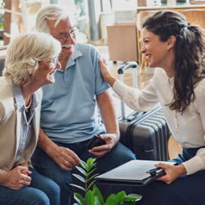 Woman speaking with elderly couple