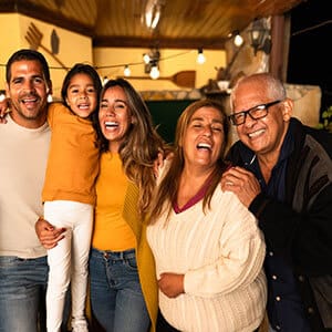 Generations of family smiling for photo in restaurant