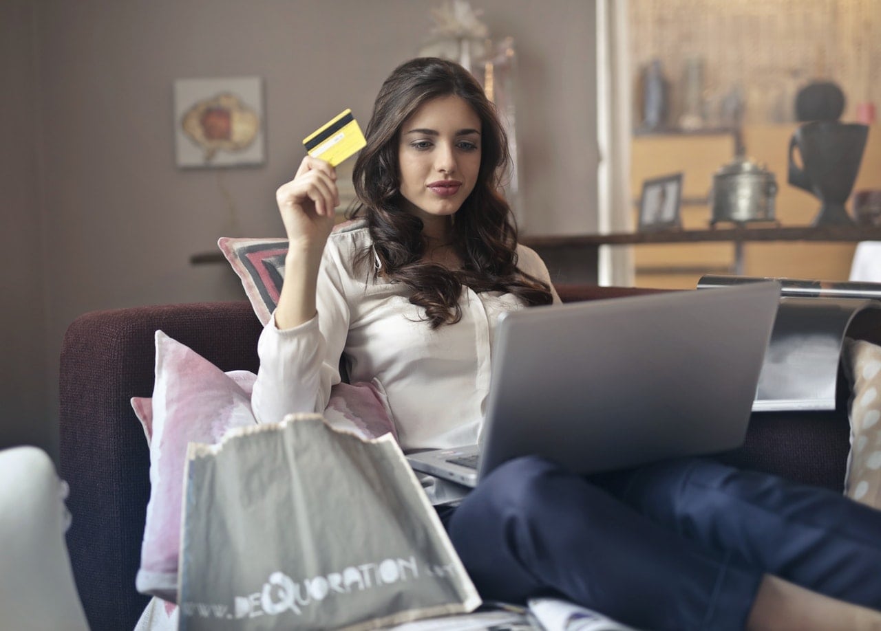 Woman sitting while holding her card